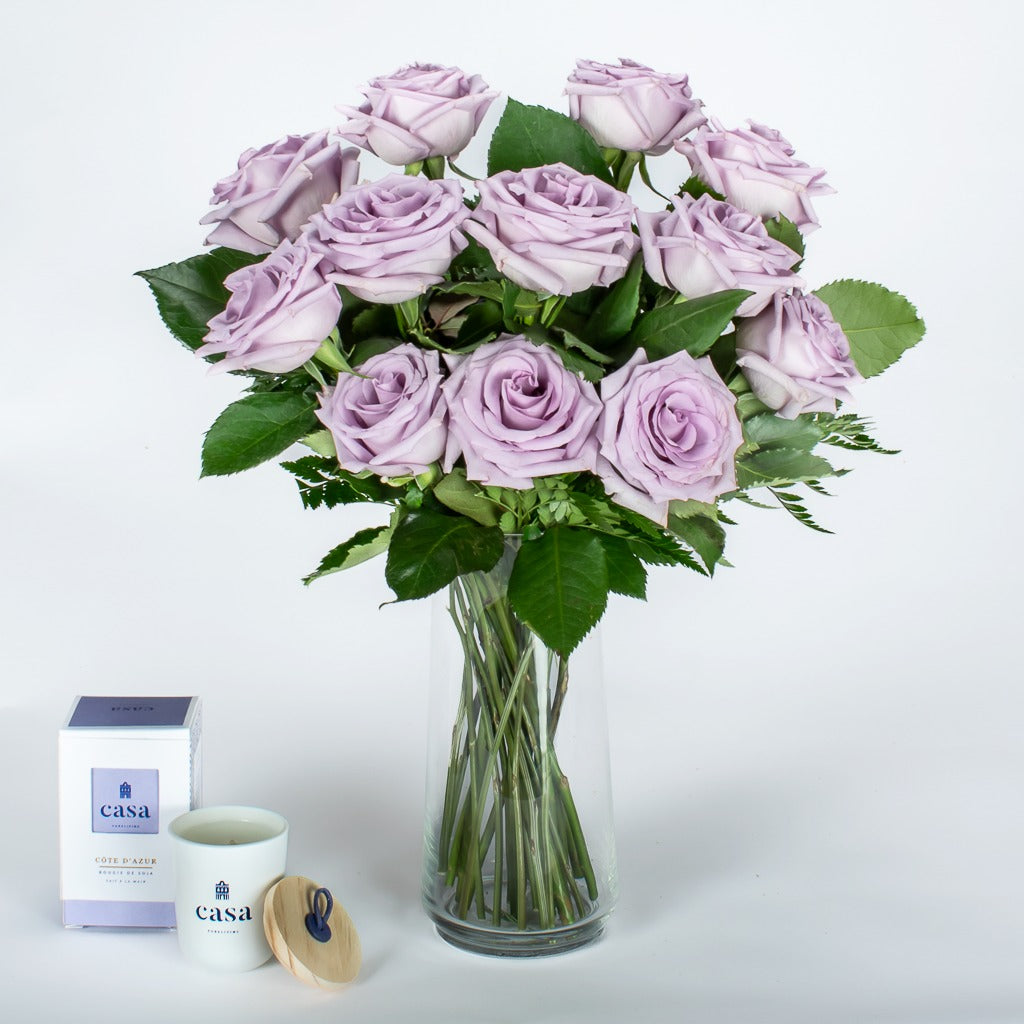 A Dozen Lavender Roses In Vase With Candle